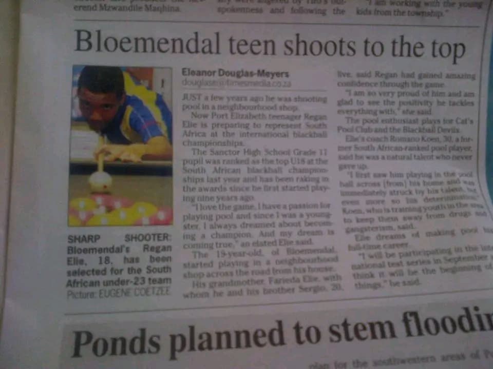 Newspaper clipping showing Regan Elie lining up a shot, captioned as a sharp shooter selected for South Africa's under-23 team
